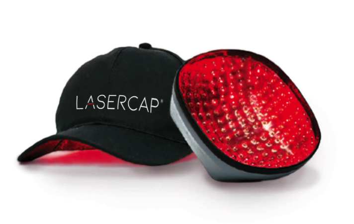 A laser cap device next to a baseball cap