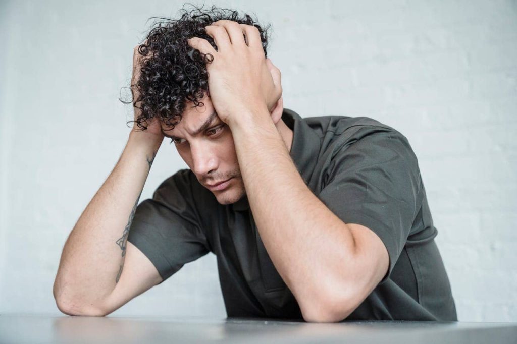 Man touching his head