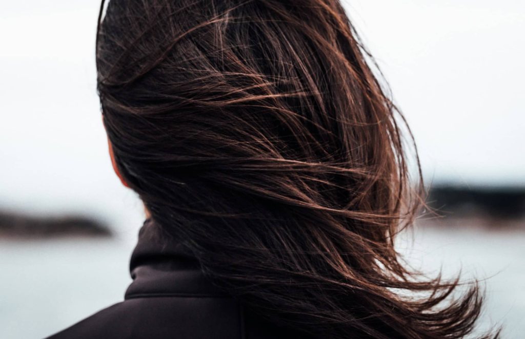 The back of a person’s head with healthy hair