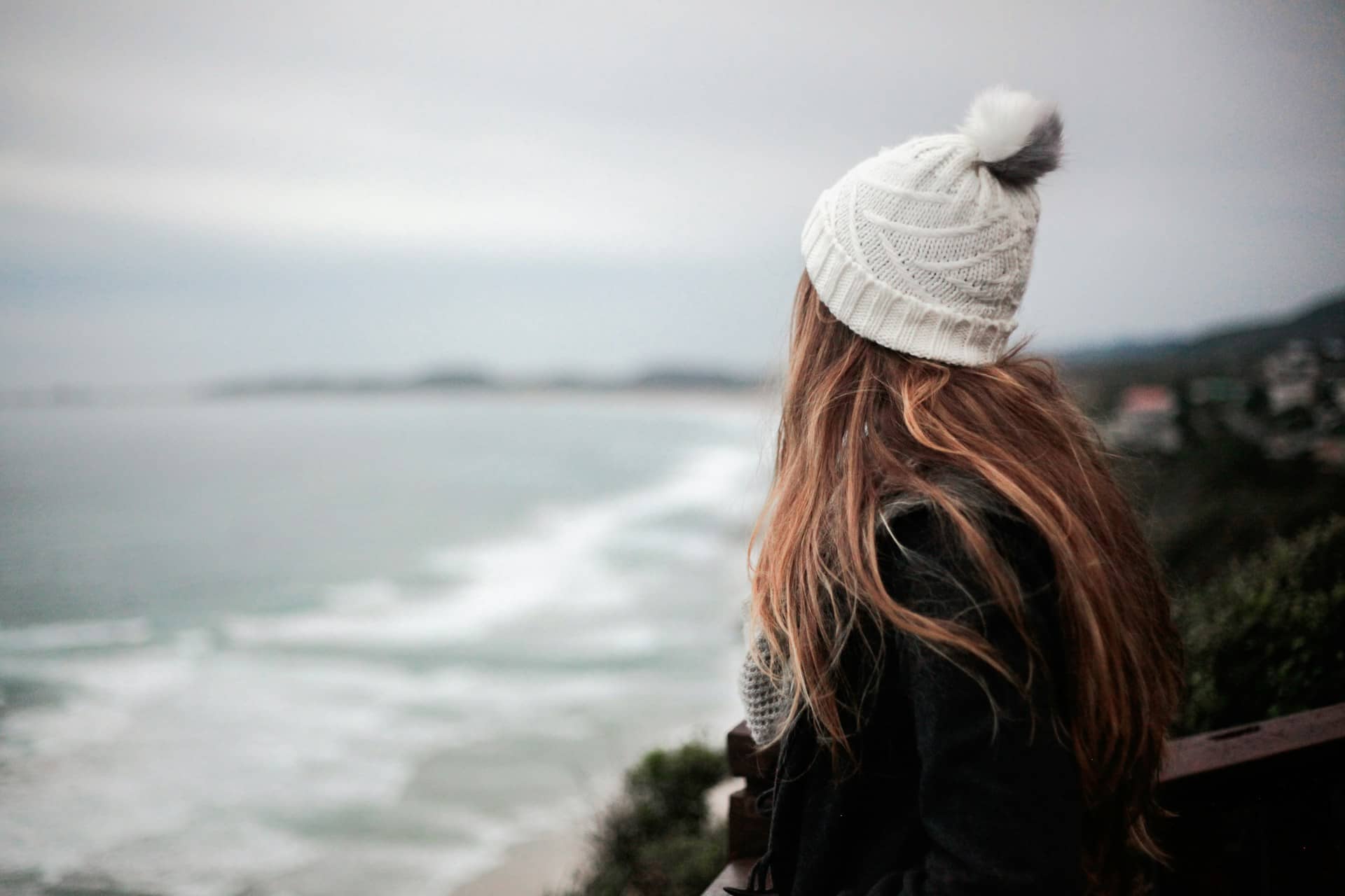 Woman Wearing A Beanie Looking At The Ocean