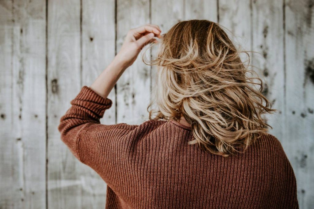 A woman touching her hair